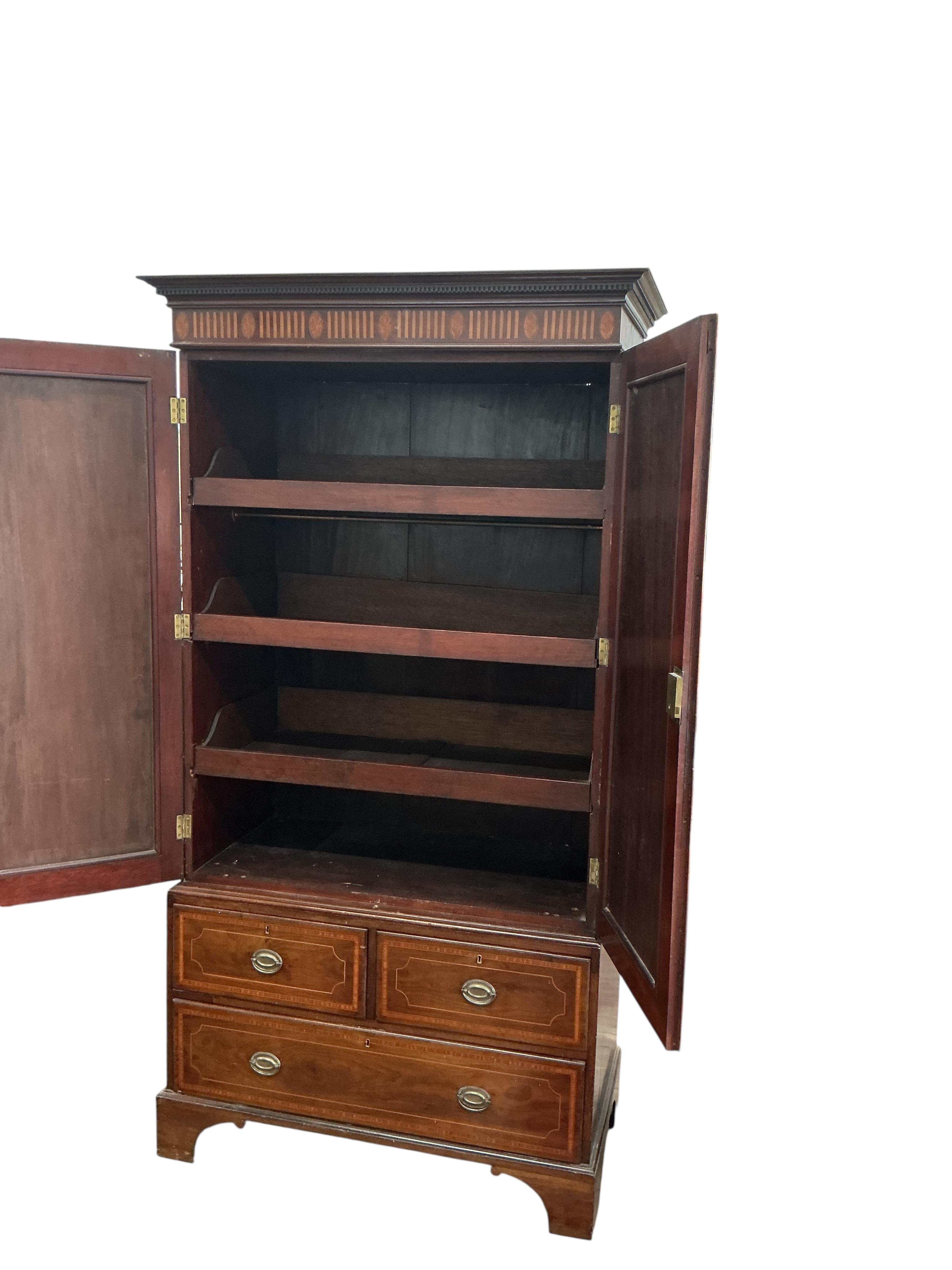 An Edwardian satinwood banded mahogany linen press, width 122cm, depth 58cm, height 230cm